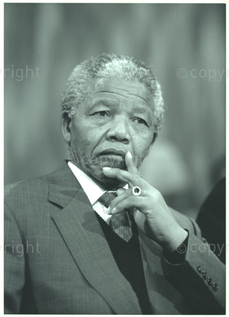 Geneva Ecumenical Centre, Geneva, Switzerland, 19900601. PHOTO: ANC Archives.

A photographic portrait of newly appointed Deputy President of the African National Congress (ANC) Nelson Mandela gazing pensively ahead of him, with his hand to his mouth a few months after his release from prison, when he and his wife, Winnie Madikizela-Mandela pay an official visit to Switzerland, 4-9 June 1990. Shortly after his arrival in Geneva, he visits the staff and officials and representatives of the World Council of Churches (WCC) at the Geneva Ecumenical Centre.