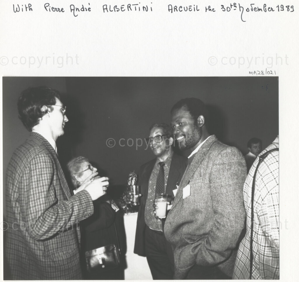 Arcueil, Val-de-Marne, Paris, Île-de-France, France, 19891130. PHOTO: ANC Archives: African National Congress comrades living in exile and members of various French anti-apartheid movements (including Pierre-Andre Albertini, a friend of the ANC and French co-operant in South Africa, left) gather in Arcueil, France on 30 November 1989 for the unveiling of a commemorative plaque for Dulcie September. Dulcie September, a South African anti-apartheid activist and ANC Chief Representative in France, Switzerland and Luxembourg, was assassinated outside the ANC's Paris office at 28 Rue des Petites-Ecuries last year on 29 March 1988.