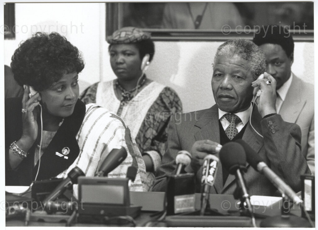 International Labour Organisation , Geneva, Switzerland, 19900608. PHOTO: ANC Archives.

Barely four months after his release from 27 years in prison the deputy president of the African National Congress (ANC), Nelson Mandela and his spouse Winnie Madikizela-Mandela embark on an official visit to Switzerland, 4-9 June 1990. On 8 June 1990, they attend the 77th Session of the International Labour Conference (ILC) hosted at the International Labour Organisation (ILO), Geneva. Seated at a table Winnie Madikizela-Mandela (front left), Nelson Mandela (front right), Nkosazana Clarice Dlamini Zuma (back left)where Nelson Mandela delivers an address to governments, employers and workers of 187 member States.