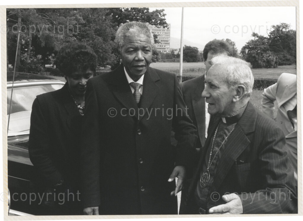 Geneva Ecumenical Centre, Geneva, Switzerland, 19900601. PHOTO: ANC Archives.

Winnie Madikizela- Mandela (left to right), recently elected Deputy President of the African National Congress (ANC) Nelson Mandela and Secretary General of the World Council of Churches Emilio Castro upon the arrival of the Mandela's couples visit to the Geneva Ecumenical Centre, Switzerland when the Mandela couple visit staff, officials and representatives of the (WCC) during Nelson Mandela's official visit to Switzerland, 4-9 June 1990. During the visit, barely a few months after his release from prison, Nelson Mandela expresses his gratitude to the church for its support of the anti-apartheid struggle.