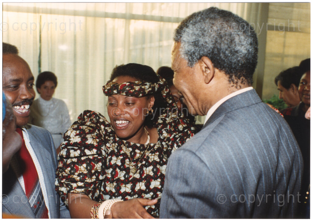 Geneva Ecumenical Centre, Geneva, Switzerland, 19900601. PHOTO: ANC Archives.

A few months after his release from prison, newly elected Deputy President of the African National Congress (ANC) Nelson Mandela and his wife, Winnie Madikizela-Mandela make an official visit to Switzerland, 4-9 June 1990. Shortly after his arrival in Geneva, he visits staff and officials and representatives of the World Council of Churches (WCC) at the Geneva Ecumenical Centre. Smiling broadly, with his back turned slightly towards the camera Nelson Mandela greets guests at the reception. During this visit, Nelson Mandela expresses his gratitude to the church for its support of the anti-apartheid struggle.