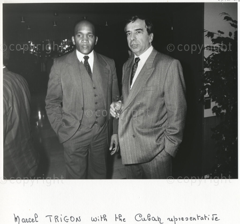 Arcueil, Val-de-Marne, Paris, Île-de-France, France, 19891130. PHOTO: ANC Archives: Mayor of Arcueil (Val-de-Marne) and figure of communism, Marcel Trigon (right) converses with a Cuban representative (left) at a function in Arcueil, France on 30 November 1989 at which a commemorative plaque for Dulcie September is unveiled. A number of African National Congress comrades living in exile and members of various French anti-apartheid movements are attending the gathering. Dulcie September, a South African anti-apartheid activist and ANC Chief Representative in France, Switzerland and Luxembourg, was assassinated outside the ANC's Paris office at 28 Rue des Petites-Ecuries last year on 29 March 1988.