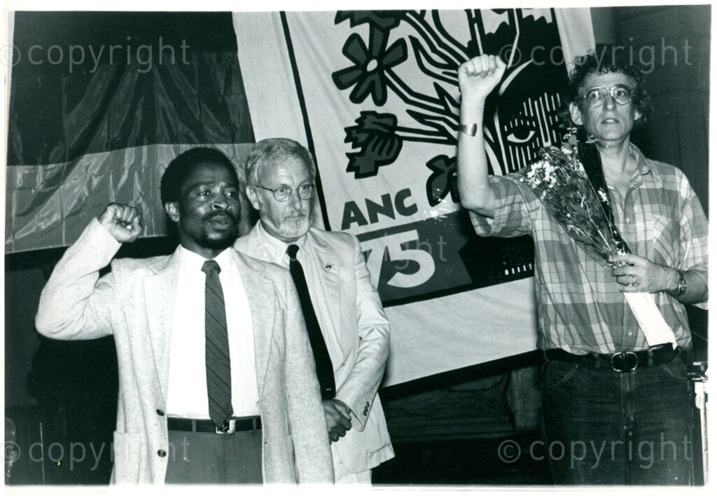 Welcoming rally for Klaas de Jonge (Dutch underground ANC operative; right) after his return from South Africa in Amsterdam, 12 September 1987; left: Massipula Mbongwa (ANC-unit Netherlands); centre: Karel Roskam (Dutch veteran anti-apartheid activist). Photographer: Inge Goijaerts.