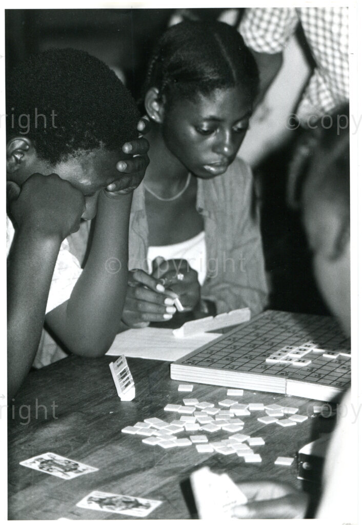 SOMAFCO students playing scrabble game  sent by Dutch AAM; Mazimbu, Tanzania, 1983. Photo: Eli Weinberg Photo Lab.