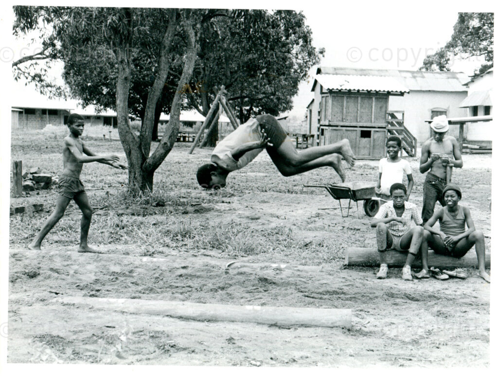 Acrobatics on the grounds of the nursery school in Mazimbu, Tanzania, December 1983. Photo: Eli Weinberg Photo Lab.