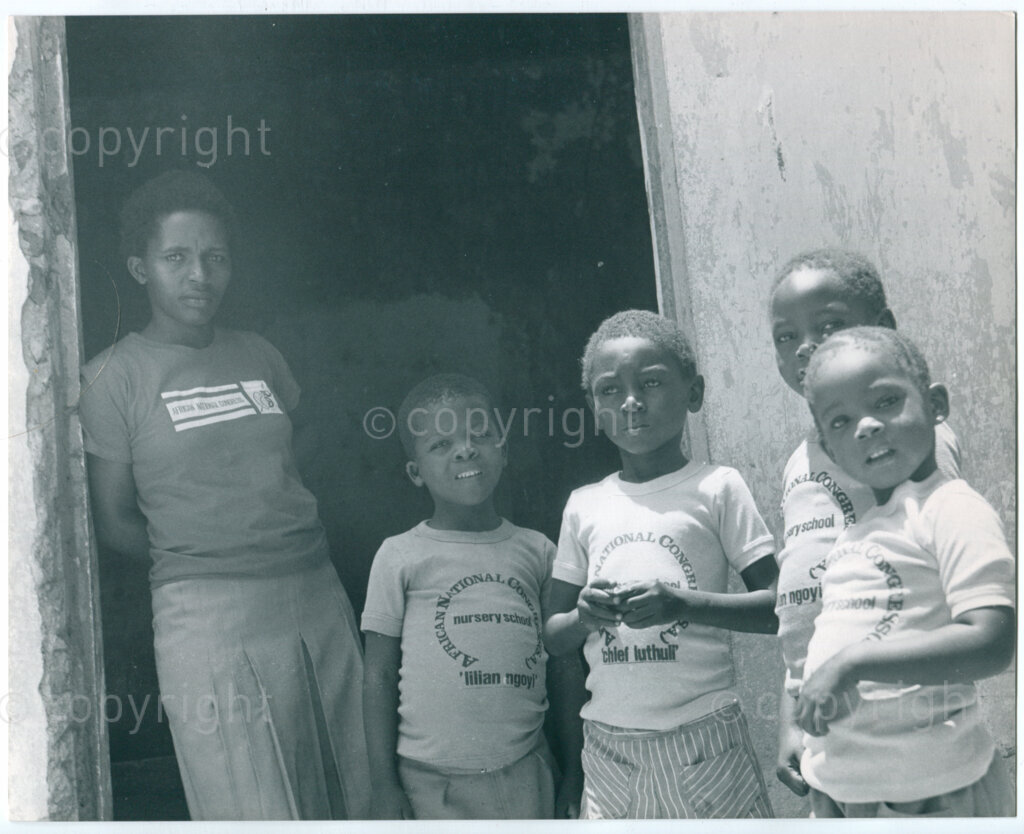 The ANC nursery school in Mazimbu, Tanzania, 1982: children and staff member with t-shirts printed in The Netherlands. Photo: Eli Weinberg Photo Lab.