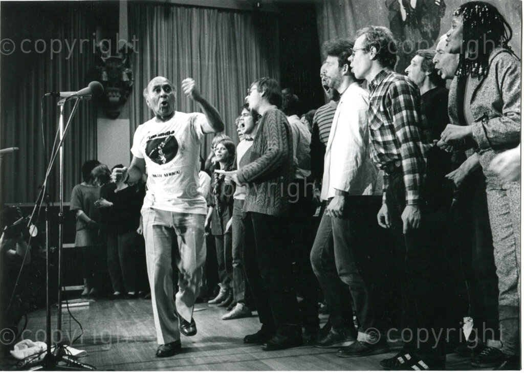 Performance by James Phillips and Dutch choirs in the Royal Tropical Museum in Amsterdam, The Netherlands, 16 December 1983. Photographer: Hans van den Bogaard.