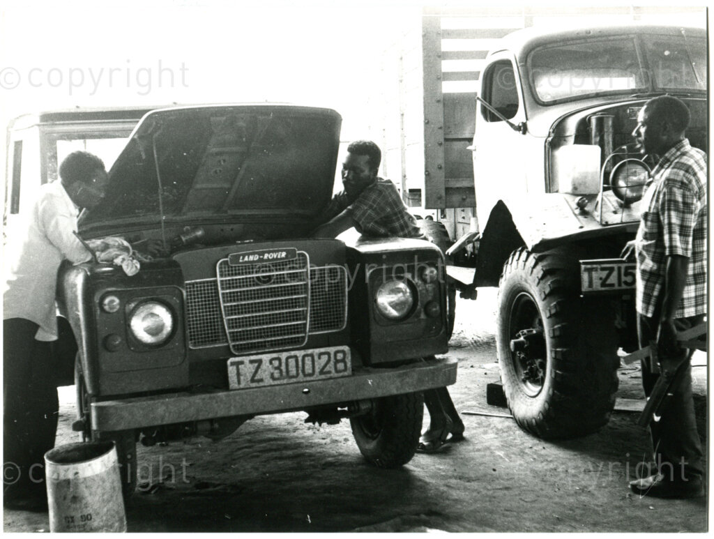 Repairs at the garage in Mazimbu, Tanzania, late 1980. Photo: Eli Weinberg Photo Lab.
