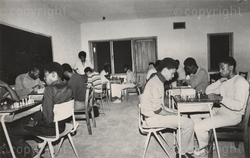 Students playing chess and other games during the school break in Mazimbu, Tanzania, 1981. Photo: Eli Weinberg Photo Lab.