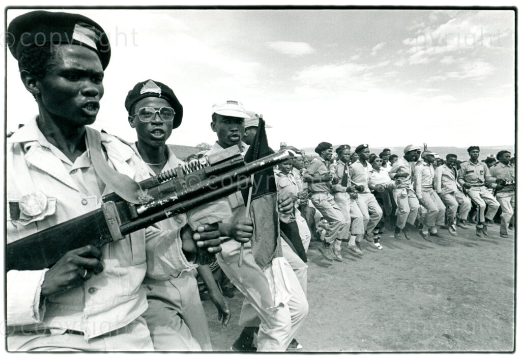 Dancing ANC members/supporters with fake AK47 at a rally in Lady Frere, Transkei, November 1990. Photographer: Pieter Boersma.