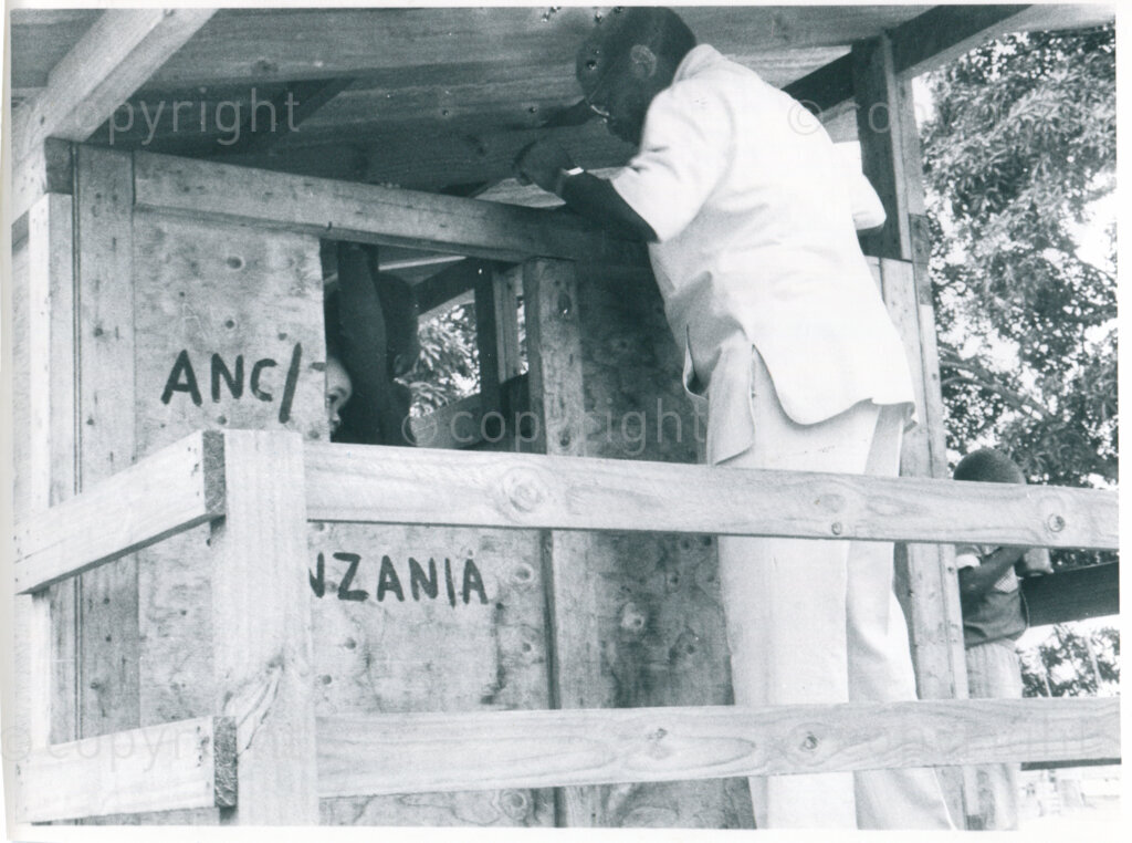 SOMAFCO Primary School: ANC president Oliver Tambo visits a play house built by the children themselves; Mazimbu, Tanzania, April 1983. Photo: Eli Weinberg Photo Lab.