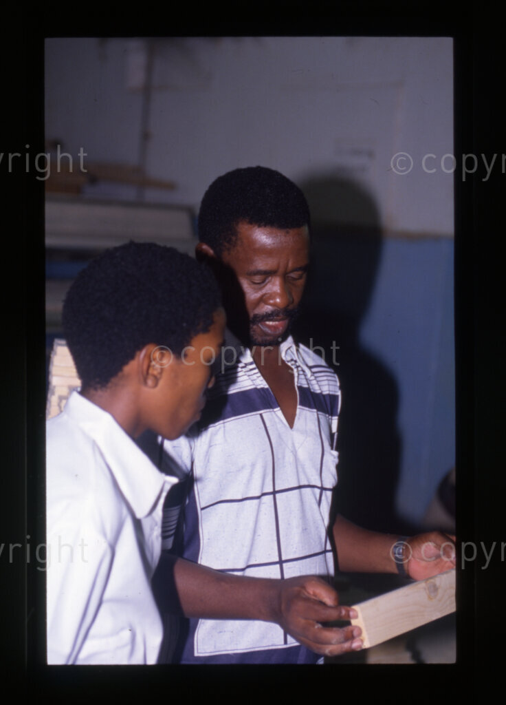 Furniture factory, including students being shown around by factory official, Mazimbu (SOMAFCO), Tanzania, 1990