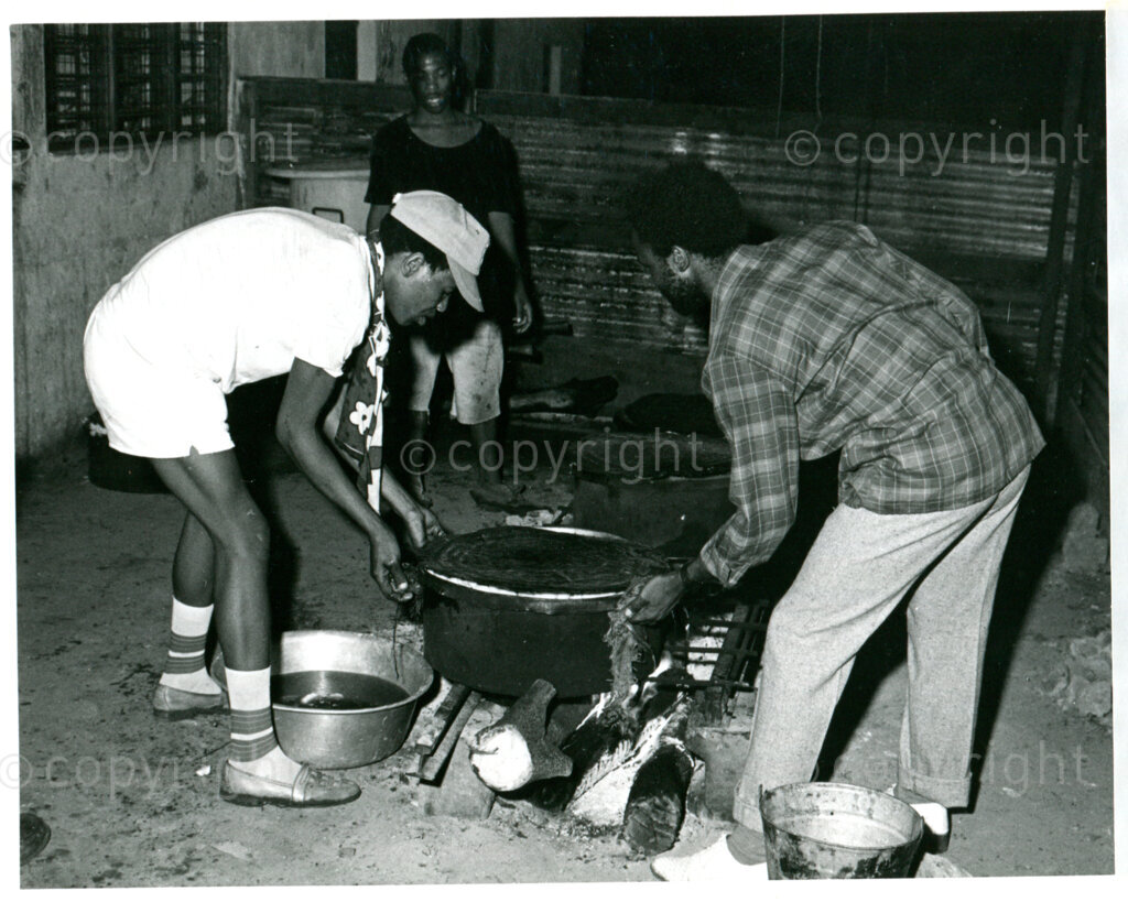 SOMAFCO students preparing food on a wood fire in Mazimbu, Tanzania, approx. 1984. Photo: Eli Weinberg Photo Lab.