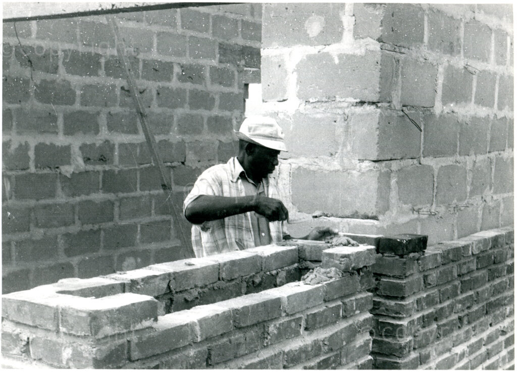 Tanzanian worker building the walls of the new school in Mazimbu, Tanzania, 1981. Photo: Eli Weinberg Photo Lab.