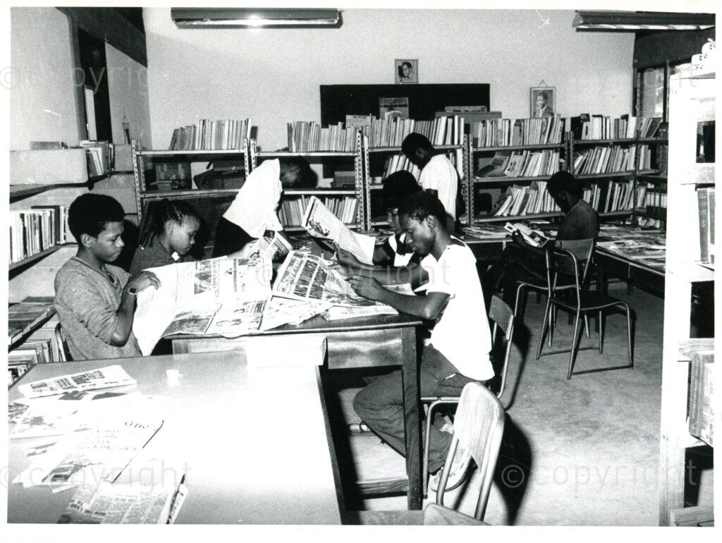 Studying in the library of Mazimbu, Tanzania, 1985?. Photo: Eli Weinberg Photo Lab.