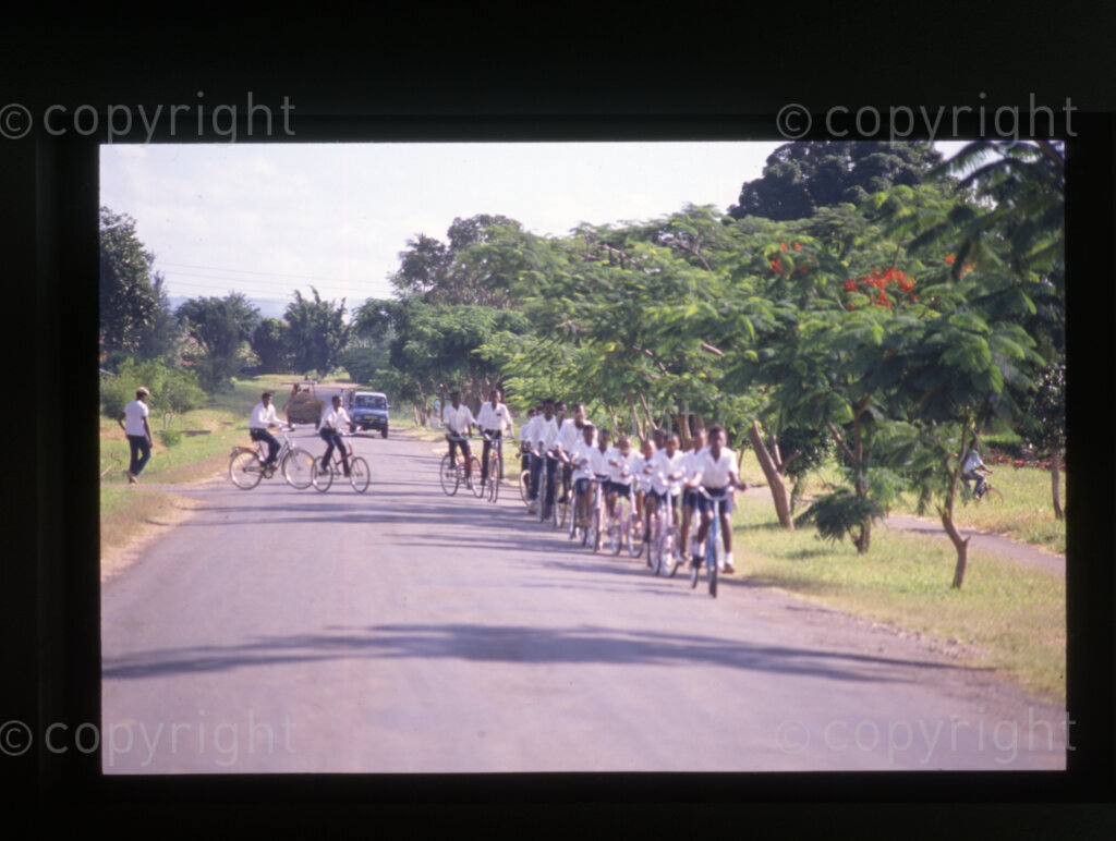Students and pupils with colourful donated bikes (most of which disappeared from Mazimbu within a year), Mazimbu (SOMAFCO), Tanzania, 1990