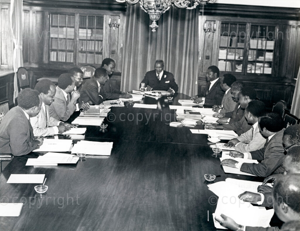 After Kenya gained independence in 1963, Jomo Kenyatta formed the first cabinet, which included several key figures who had been instrumental in the independence movement. Kenyatta's cabinet was composed of leaders from the Kenya African National Union (KANU) and was designed to reflect a broad coalition of Kenya's diverse communities. Tom Mboya, a pivotal figure in the independence struggle, was appointed Minister of Justice and Constitutional Affairs, and later became the Minister of Economic Planning and Development. In these roles, Mboya was crucial in shaping Kenya's economic policies and development plans, contributing significantly to the new nation's growth and modernization efforts.