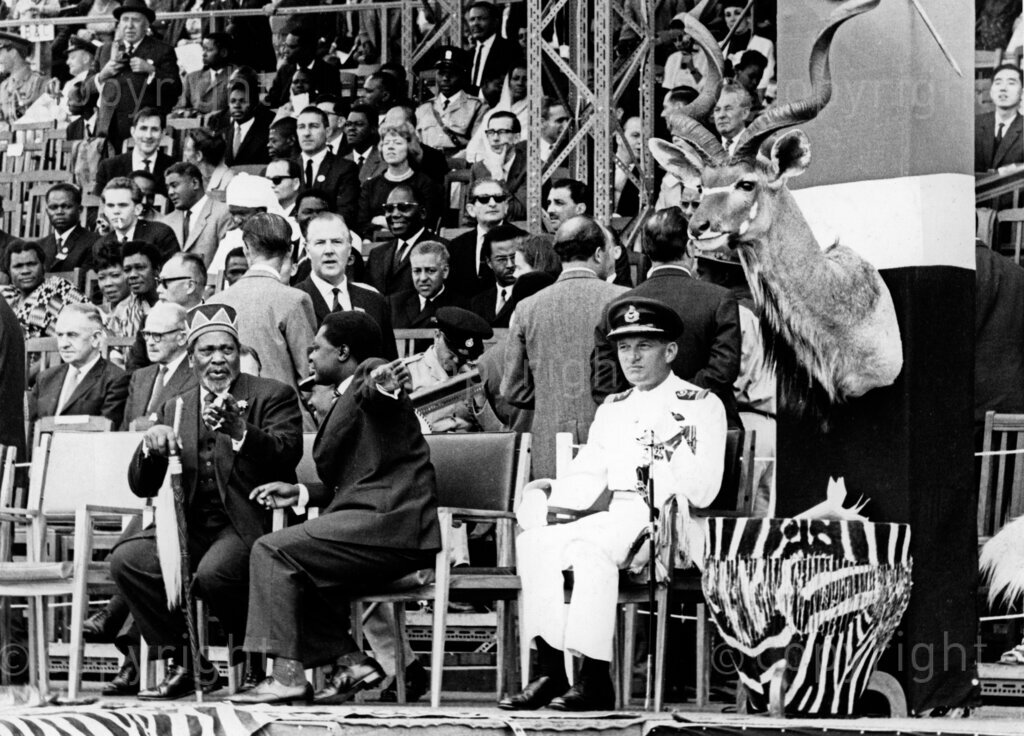 On Kenya's Independence Day, December 12, 1963, Kenyatta was the prime minister and later became the first president of the Republic of Kenya. Tom Mboya, a prominent trade unionist and politician, was a key figure in the independence movement and served as Minister of Justice and Constitutional Affairs, and later as Minister for Economic Planning and Development in Kenyatta's government. During the celebrations, Kenyatta addressed the nation, highlighting the significance of achieving independence and the responsibilities that came with it. Mboya, known for his eloquence and strategic thinking, was instrumental in organizing the independence festivities and played a crucial role in the negotiations that led to Kenya's self-governance. The day was marked by joyous celebrations, parades, and the symbolic lowering of the British flag and raising of the Kenyan flag, signifying the end of colonial rule and the beginning of a new era for Kenya.