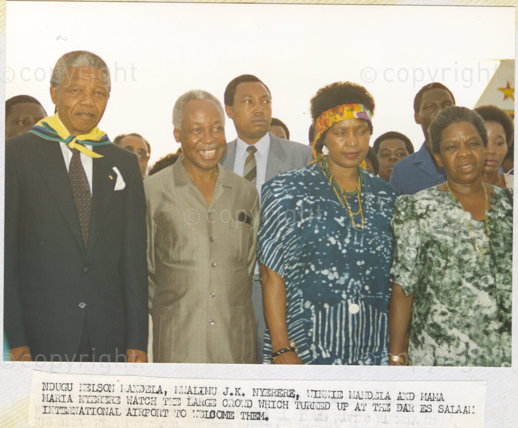 Dar Es Salaam, Tanzania. PHOTO: ANC Archives. 6 March 1990. Nelson Mandela, deputy president of the African National Congress (ANC), (from left), Julius Nyerere, chairman of the Chama Cha Mapinduzi (CCM) Tanzanian ruling party, Winnie Mandela and Maria Nyerera view the enormous crowd that turns out to meet the Mandelas when they arrive at Dar Es Salaam International Airport. The Mandelas are touring African states which support the liberation struggle in South Africa.