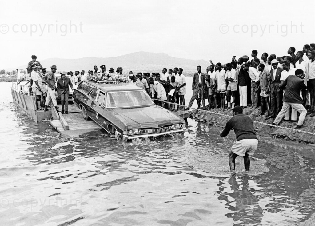 Tom Mboya's cortège reaches Rusinga Island, marking the final leg of his journey home. Thousands of mourners gathered to pay their respects to the fallen statesman, whose assassination shook the nation. The solemn procession winds through the island, a poignant tribute to Mboya's lasting legacy in Kenya's history.