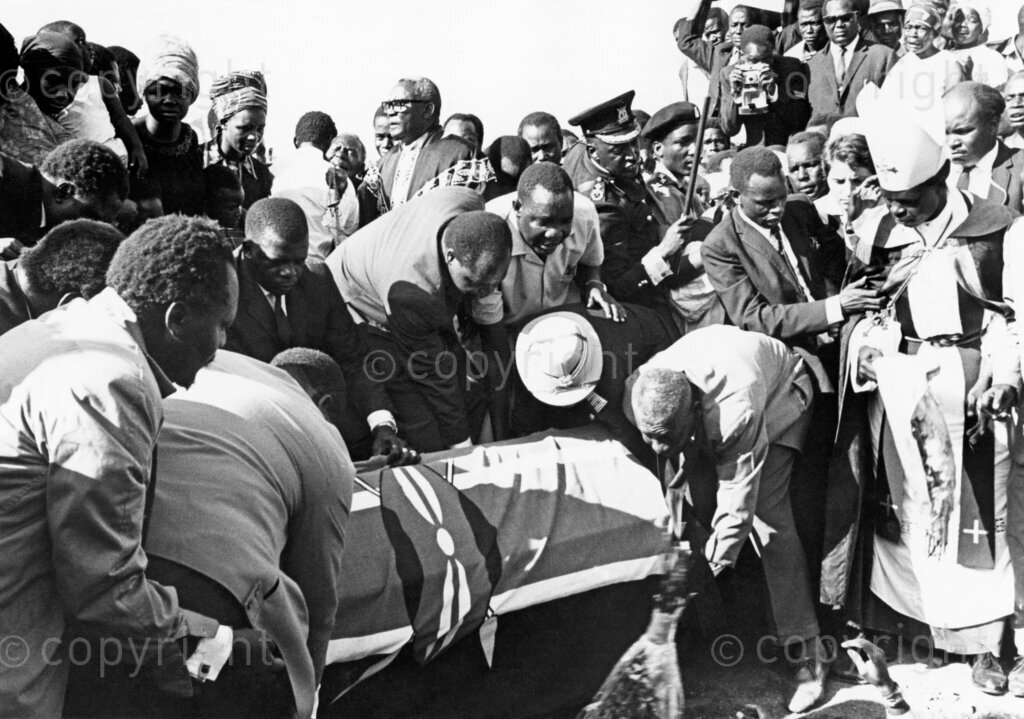 Draped in the Kenyan flag, Tom Mboya is laid to rest at Rusinga Island, honored for his dedication and service to the nation.