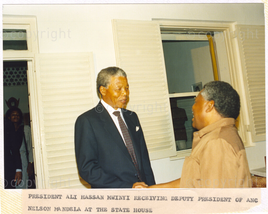 Dar Es Salaam, Tanzania. PHOTO: ANC Archives. 6 March 1990. Tanzanian President Ali Hassan Mwinyi (right), welcomes Nelson Mandela, deputy president of the African National Congress (ANC), to the State House in Dar Es Salaam, Tanzania. Mandela and his wife, Winnie are on a tour of African states which support the liberation struggle in South Africa.