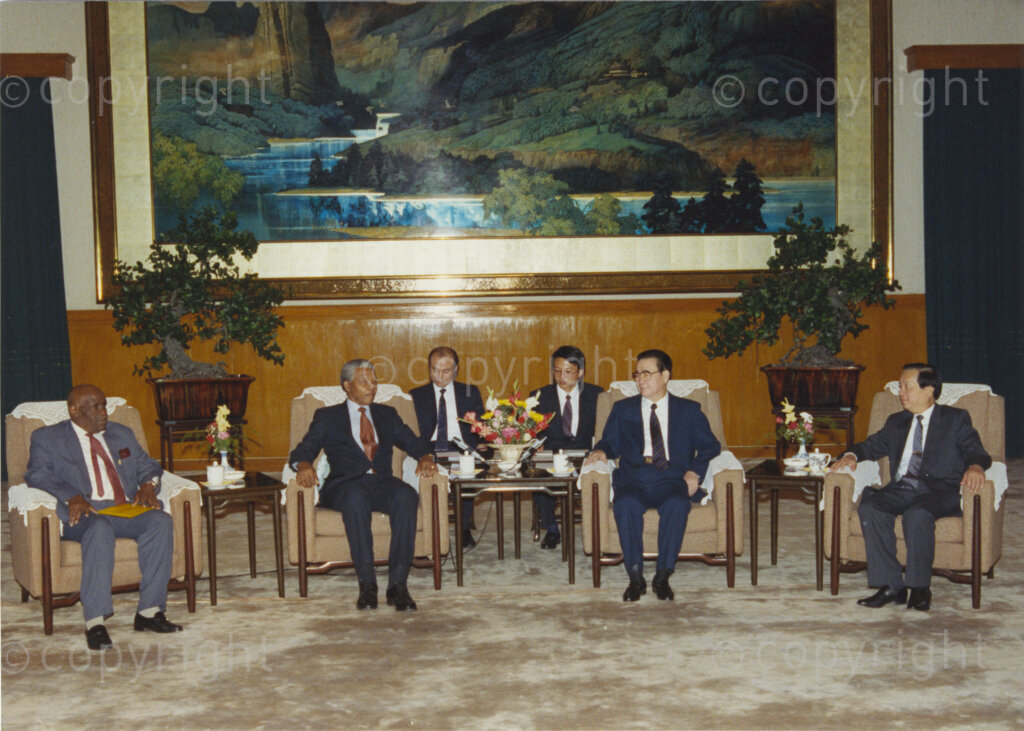 The Great Hall of the People, Beijing, Beijing Municipality, People's Republic of China , 19921006. PHOTO: ANC Archives.

The President of the African National Congress, Nelson Mandela, accompanied by the ANC spokesman, Mr Pallo Jordan, visits the People's Republic of China (PRC) in October 1992. The weeklong visit to China involves discussions towards establishing official ties between a Greater China (including PRC and the Republic of China) and South Africa. A number of welcoming ceremonies are held at which the ANC delegates meet with Chinese dignitaries including President Yang Shangkun and the Chinese Communist Party General Secretary, Jiang Zemin. On the 6 October Nelson Mandela (second left) meets with Prime Minister Li Peng (second right) at The Great Hall of the People in Beijing. On the same day, Nelson Mandela visits Peking University where he speaks to assembled students and is awarded an honorary doctorate. (After many years of strong lobbying by the PRC, and engagement with Nelson Mandela, official relations between the PRC's 'One China' and South Africa were established in 1998.)