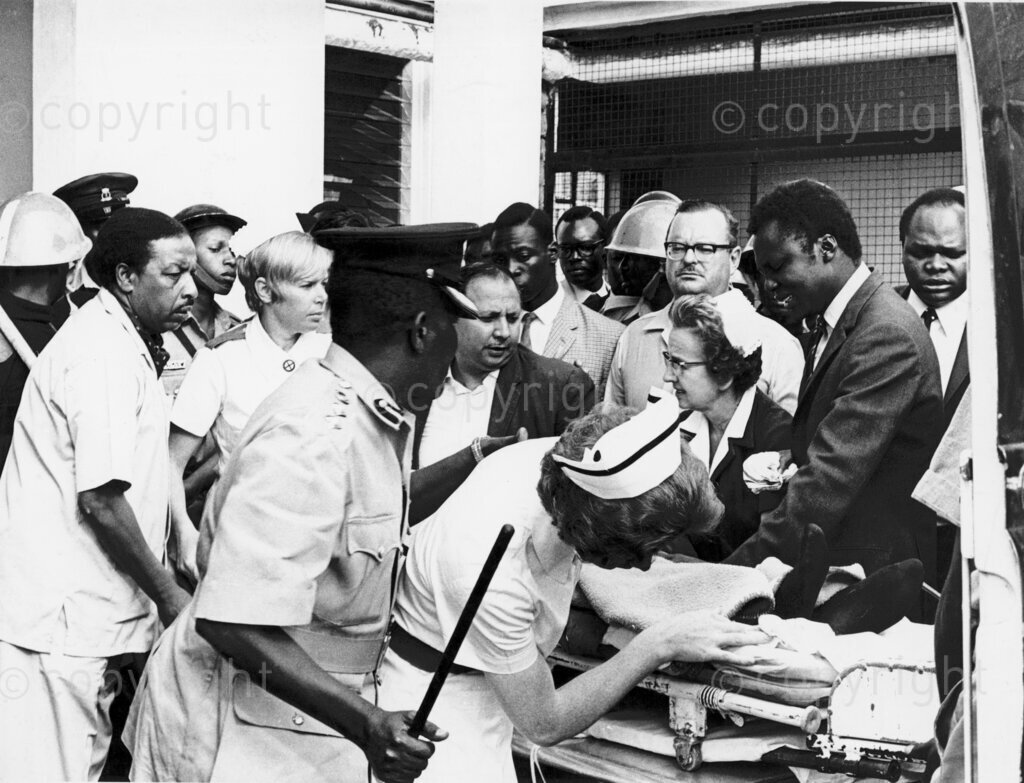 A nurse checks on Tom Mboya after arrival at Nairobi Hospital.