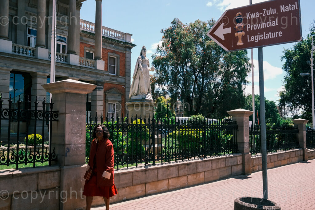 Figures in a 'Scape. Victoria, queen and empress. Stands outside the provincial parliament of KwaZulu-Natal on Langalibalele Street. The province of Natal was once known as the last stronghold of the British Empire. Oct. 2024, Pietermaritzburg, South Africa.
