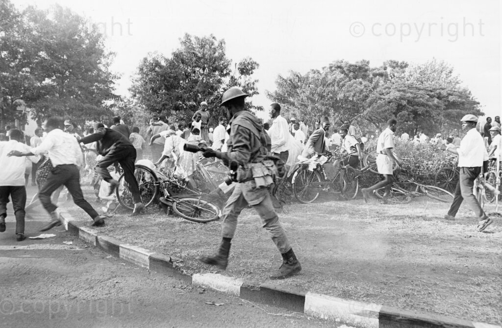 Tensions explode in Kisumu as angry crowds clash with police, who fire tear gas to disperse protesters mourning the assassination of Tom Mboya. The streets are filled with chaos as the nation grapples with the loss of one of its most prominent leader.