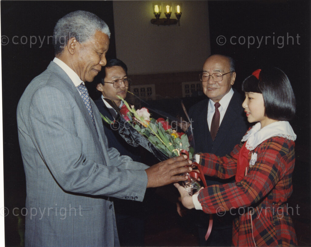 Great Hall of the People, Beijing, Beijing Municipality, People's Republic of China , 19921005. PHOTO: ANC Archives.

The President of the African National Congress, Nelson Mandela, accompanied by the ANC spokesman, Mr Pallo Jordan, visits the People's Republic of China (PRC) in October 1992. At this time South Africa recognises Taiwan (ROC) as independent from the PRC, and Nelson Mandela is in support of a 'Two Chinas' policy. The weeklong visit to China involves discussions towards establishing official ties between a Greater China (including PRC and ROC) and South Africa. President Yang Shangkun (second right) and the Chinese Communist Party General Secretary, Jiang Zemin, greet Mr Mandela (left) at a welcoming ceremony at the Great Hall of the People in Beijing on the 5 October 1993. After many years of strong lobbying by the PRC, and engagement with Nelson Mandela, official relations between the PRC's 'One China' and South Africa were established in 1998.