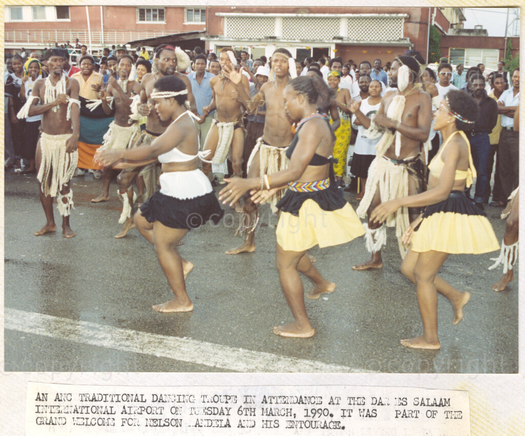 Dar Es Salaam, Tanzania. PHOTO: ANC Archives. 6 March 1990. An African National Congress (ANC), traditional dancing group perform their routine at the Dar Es Salaam International Airport. This is part of the grand welcome for Nelson Mandela, deputy president of the African National Congress (ANC), and his wife, Winnie, on their arrival in Tanzania. The Mandelas are on a tour of African states which support the liberation struggle in South Africa. Nelson Mandela was released from prison just one month ago.