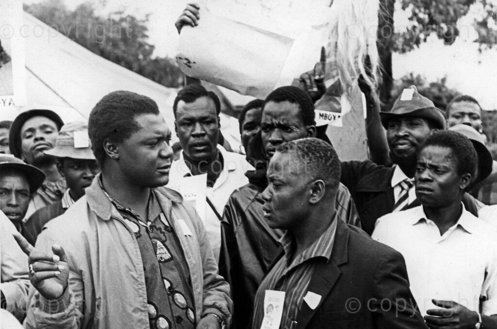 Tom Mboya, a charismatic and influential leader, often engaged in vibrant conversations with KANU supporters, fostering a deep sense of camaraderie and enthusiasm. Known for his eloquence and visionary ideas, these interactions showcased his ability to inspire and mobilize the masses, contributing significantly to KANU's strong grassroots support. These exchanges often revolved around the vision for a united and progressive Kenya, discussing strategies, and addressing supporters' concerns, thereby solidifying Mboya's status as a key architect in Kenya's political landscape.