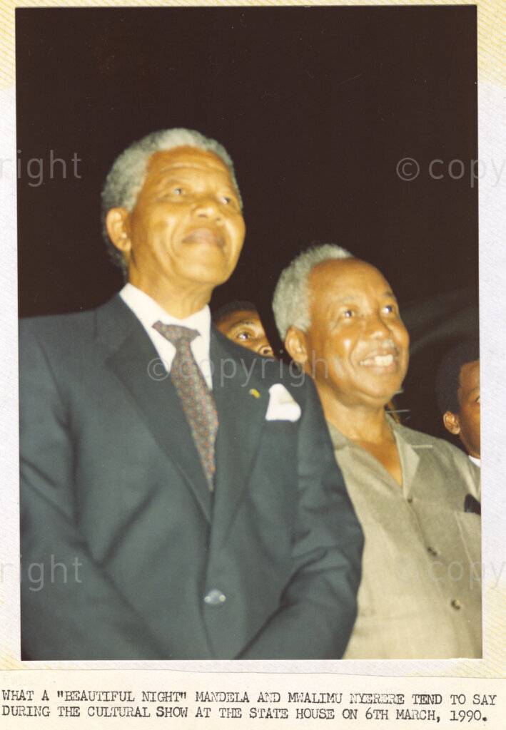 Dar Es Salaam, Tanzania. PHOTO: ANC Archives. 6 March 1990. Enjoying the cultural show presented at the Dar Es Salaam State House, Deputy President of the African National Congress (ANC), Nelson Mandela (left), stands beside Julius Nyerere, chairman of the Chama Cha Mapinduzi (CCM). Nelson and Winnie Mandela are on a tour of African states which support the liberation struggle in South Africa. It is only one month since Mandela was released from prison.