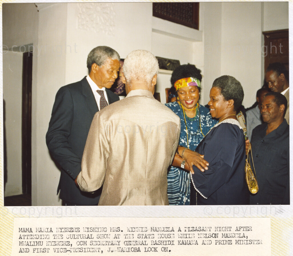 Dar Es Salaam, Tanzania. PHOTO: ANC Archives. 6 March 1990. Maria Nyerere (right), wishing Winnie Mandela a pleasant night after attending the cultural show at the State House in Dar Es Salaam, Tanzania. Nelson Mandela (left), deputy president of the African National Congress (ANC), and Julius Nyerere, Chama Cha Mapinduzi (CCM) chairman, look on. Nelson and Winnie Mandela are on a tour of African states which support the liberation struggle in South Africa.