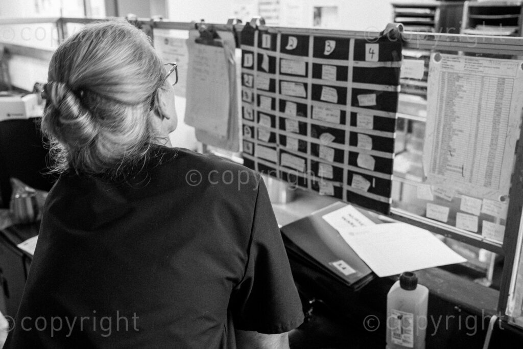 A physiotherapist scans the ward bed lists for patients in need of physiotherapy treatment. 22, 23, Feb. 2024, Pietermaritzburg, KwaZulu Natal, South Africa.