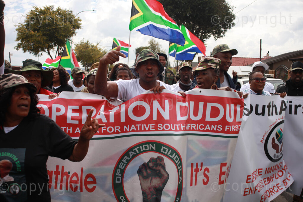 Operation Dudula members singing struggle songs outside on the streets during the funeral service of Kgomotso Diale held at Pimville Community Centre in Soweto, Johannesburg in Gauteng, South Africa. 23/04/2022 Photo: Oupa Nkosi 