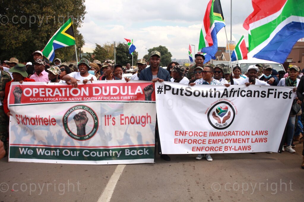 Operation Dudula members singing struggle songs outside on the streets during the funeral service of Kgomotso Diale held at Pimville Community Centre in Soweto, Johannesburg in Gauteng, South Africa. 23/04/2022 Photo: Oupa Nkosi 