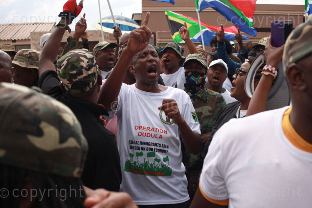 Operation Dudula members singing struggle songs outside on the streets during the funeral service of Kgomotso Diale held at Pimville Community Centre in Soweto, Johannesburg in Gauteng, South Africa. 23/04/2022 Photo: Oupa Nkosi 