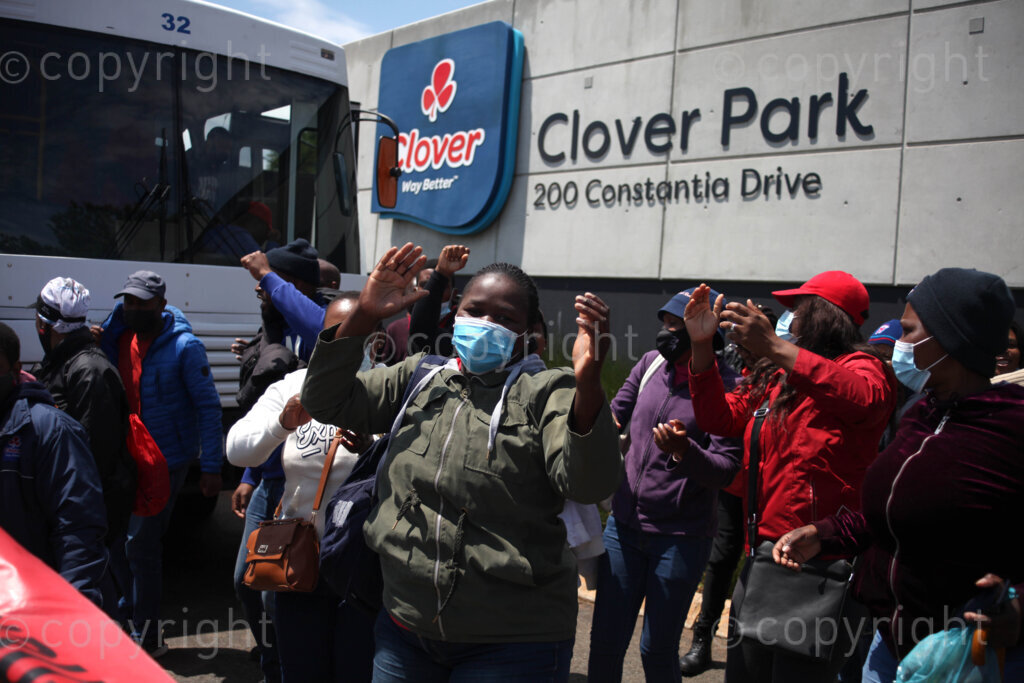 Members of Food and Allied Workers Union (FAWU) and General Industries Workers Union of South Africa (GIWUSA) together with members of civil society demonstrating at the Clover SA head offices at Constantia Kloof, Rooderkop in the east of Johannesburg, Gauteng in South Africa as the strike intensified. In 2019, Clover was bought by MILCO Consortium from Israel's top manufacturer and distributor of beverages, Central Bottling Company. 02/12/2021 Photo: Oupa Nkosi