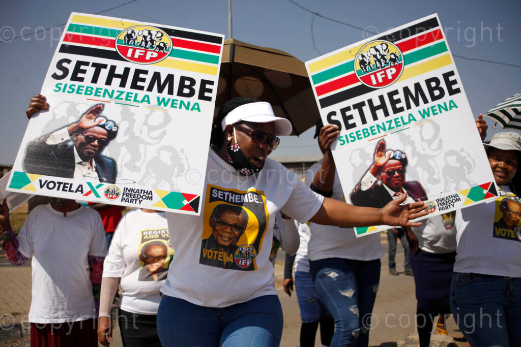 Inkatha Freedom Party (IFP) supporters from Nancefield Hostel in Klipstruit, Soweto, south east of Johannesburg in Gauteng, South Africa wearing their party t-shirts and singing struggle songs after they hanging posters on the street poles around Fred Clark township a day before the local election registration process on 17 Sep 2021. Photo: Oupa Nkosi