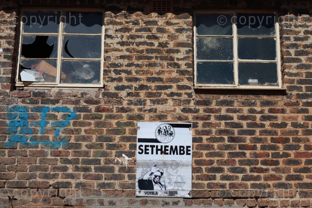 An Inkatha Freedom Party (IFP) poster with the face of the late leader Mangosuthu Buthelezi hanging on the wall at the Diepkloof hostel in Soweto, south east of Johannesburg in Gauteng, South Africa. 29 June 2023 Photo: Oupa Nkosi