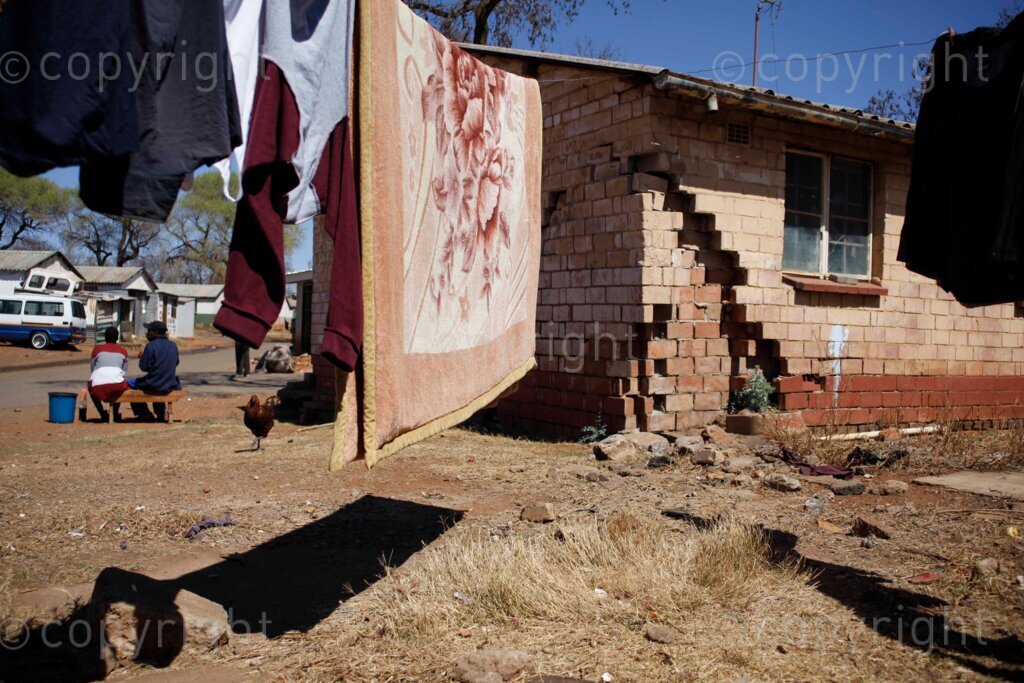 A makeshift washing line supported by a dilapidated blocks of rooms at the Nancefield Hostel in Klipstruit, Soweto, south west of Johannesburg in Gauteng, South Africa on 31 August 2021. Photo: Oupa Nkosi 