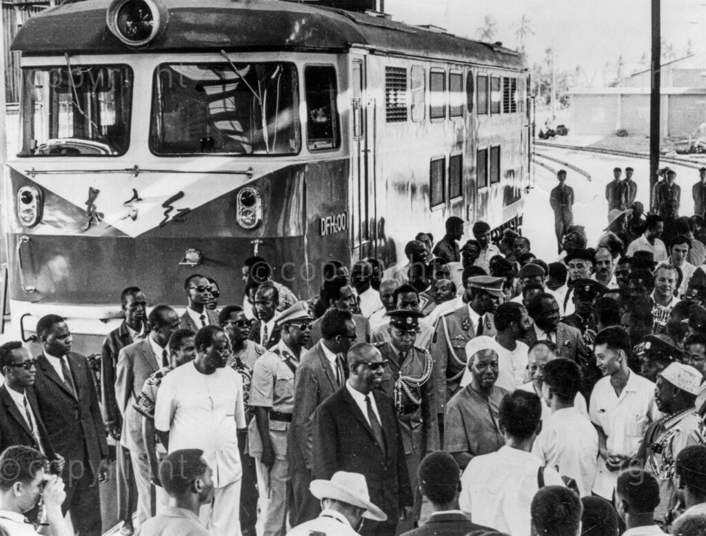 President Julius Nyerere shows his guests, President of Somalia, Siad Barre (on President Nyerere's right) and President of Burundi, Michel Micombero (behind Barre) the new Chinese railway.