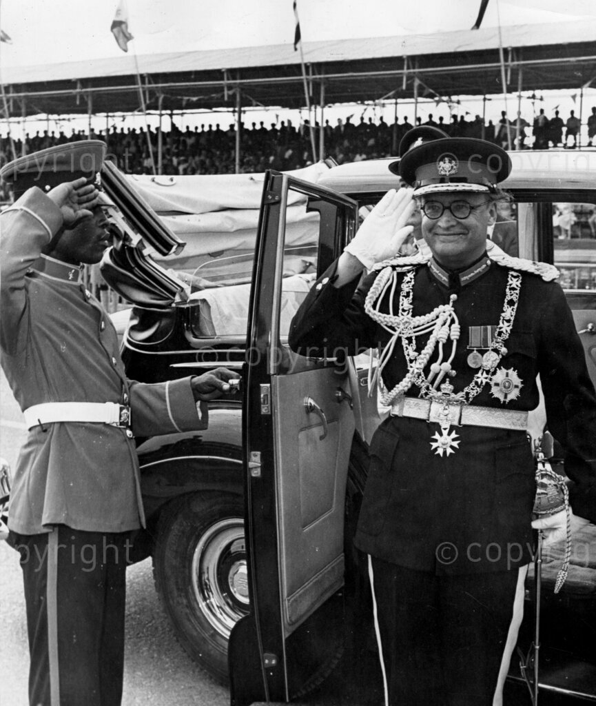 Lord Listowel (last Governor of the Gold Coast). Out of his car, he salutes as the Ghana Reconnaissance Squadron gives a 21-gun salute.