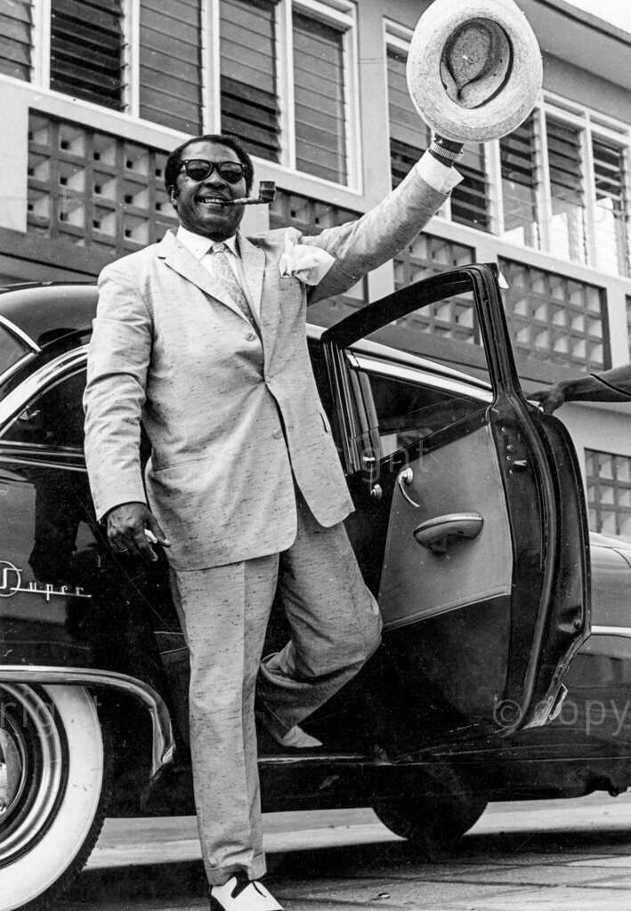 Meet Mister Snob – Dick Everett. Dressed to kill; a silk handkechief flying from his breast pocket, dandy Dick Everett sets out in his huge car to show the town who really runs it. He sits at the wheel like a Lord Mayor who has just married a wealthy princess. Dick Everett, a draughtman and artist of long standing. What a man, he admitted he acted big, talked big, drank bit, ate big. And he defended it. It was not until much later, in the naturalness of his home, that I found out Dick was just putting on an act, that it was all part of his philosophy of 