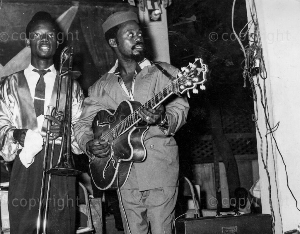 Mr Bobby Benson playing guitar, the history of music in Nigeria cannot be written without the name of Bobby Benson coming into it. Although no musician himself, he made the music.