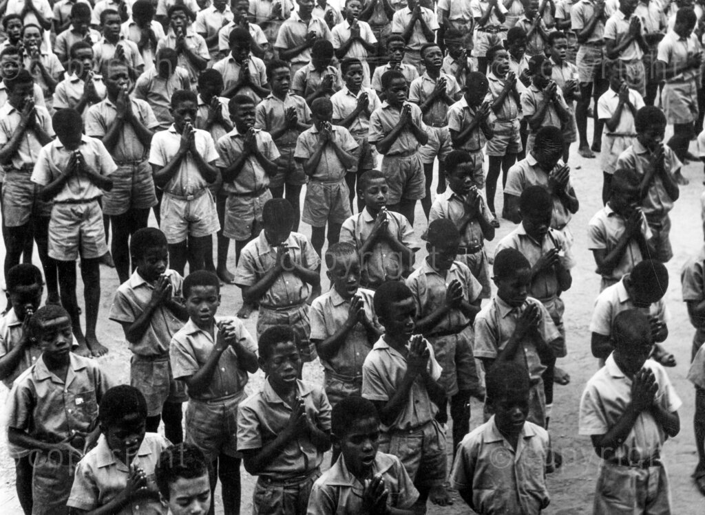 International schools vs State schools. Khaki-clad, bare footed state school boys at a morning parade. 