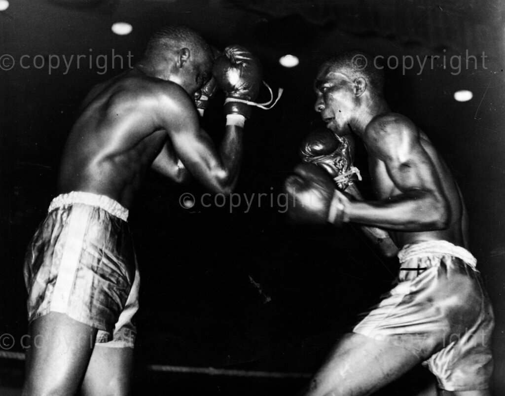 Victory's Victor. Victor Paul vs Love Muka. A typical incident from the fight. Love Muka (left) looks apprehensive as Victor Paul weaves for an opening to attack. He deserves that title too! Nigerian featherweight boxers. Victor Paul in his smashing win over the game champion Love Muka, he has proved his point and punctuated the argument with round blobs of flying leather.