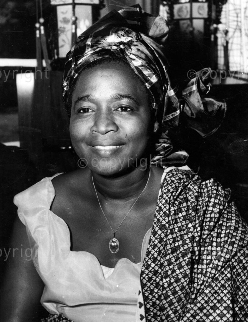 Ladies who keep our top men going. Mrs Victoria Okotie Eboh, wife of Federal Finance Minister Mr Okotie-Eboh. The top politicians are imposing figures; important busy, powerful. They live lives of pressure. The burdens of office are ever with them. How much they depend on the security of their homes, on their children, and on their wives who know the secret of man's happiness!